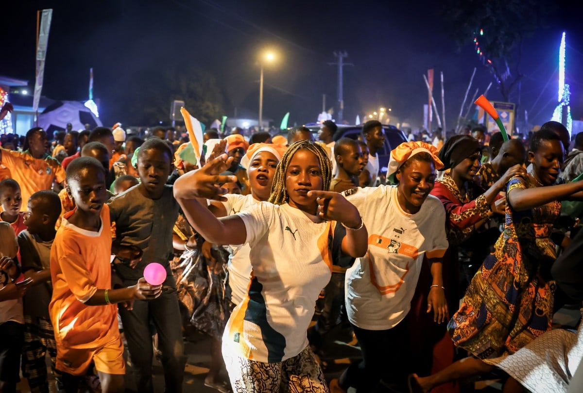 Ivorian supporters parade down the street in Korhogo, northern Ivory Coast, on January 13, 2024, atfer the Ivory coast footnall team won the football match between Ivory Coast and Guinea-Bissau during the 2024 Africa Cup of Nations